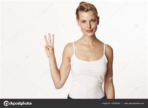 Woman Holding Up Three Fingers Stock Photo By ©sanneberg 147069169
