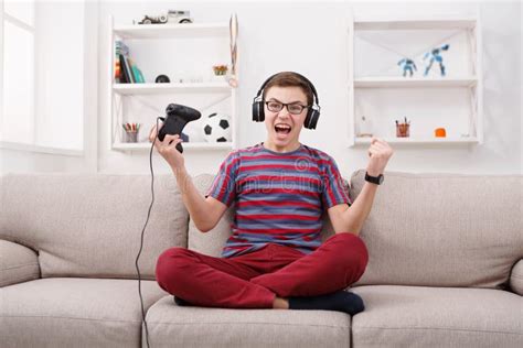 Excited Teenage Boy Playing Video Game At Home Stock Image Image Of