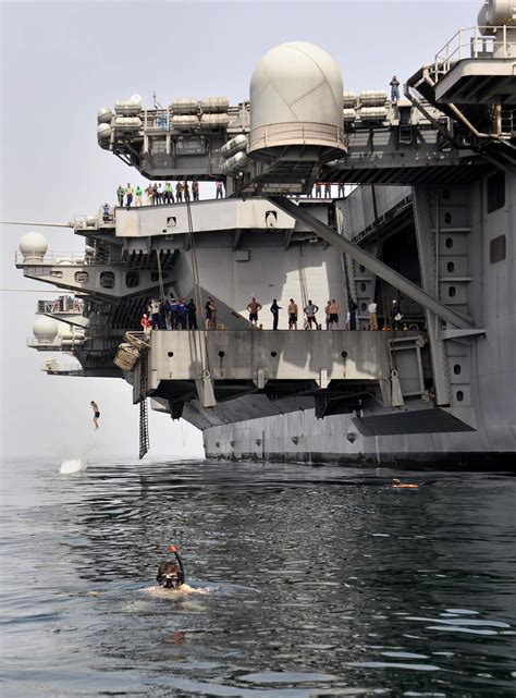 Sailors Jump Off Aircraft Elevator No 4 During A Swim Call Aboard The