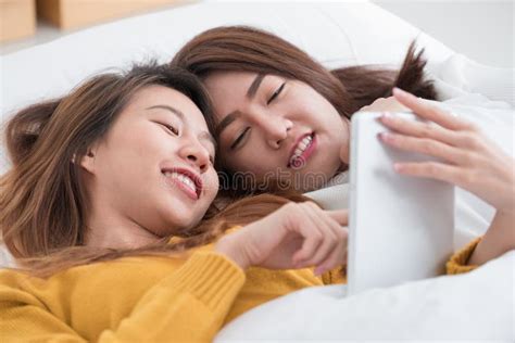 Asia Lesbian Lgbt Couple Lay On Bed And Hug Rainbow Color Pillow Heart