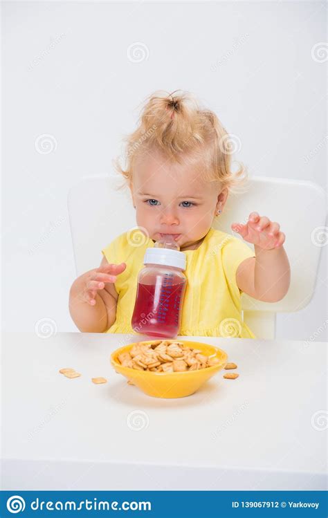 Cute Little Baby Girl 1 Year Old Eating Cereal Flakes And
