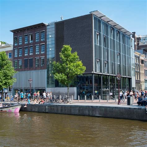 Anne Frank House And Museum In Amsterdam With Tourists In Front Of The