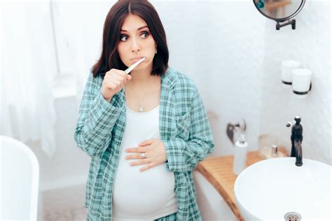 Pregnant Woman Brushing Her Teeth In The Bathroom The Pulse
