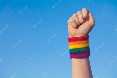 Premium Photo Gay Pride Concept Hand Making A Fist Sign With Gay Pride Lgbt Rainbow Flag Wristband