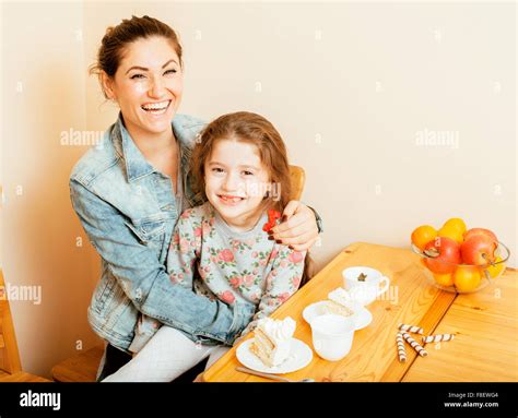 Una Joven Madre Con Su Hija En La Cocina Bebiendo Té Juntos Abrazos