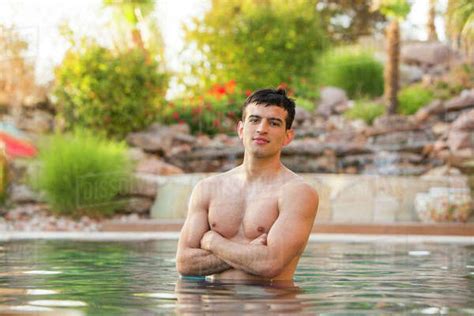 Hispanic Man Standing In Swimming Pool Stock Photo Dissolve
