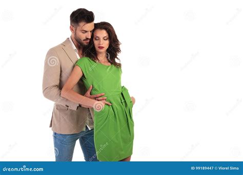Man Standing Behind His Woman And Holds Her By Waist Stock Image