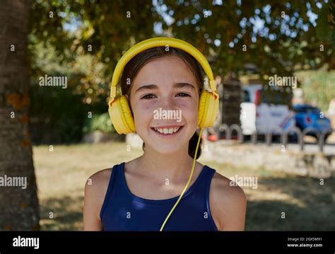 close up of a beautiful spanish girl who smiles and looks to the camera and used yellow