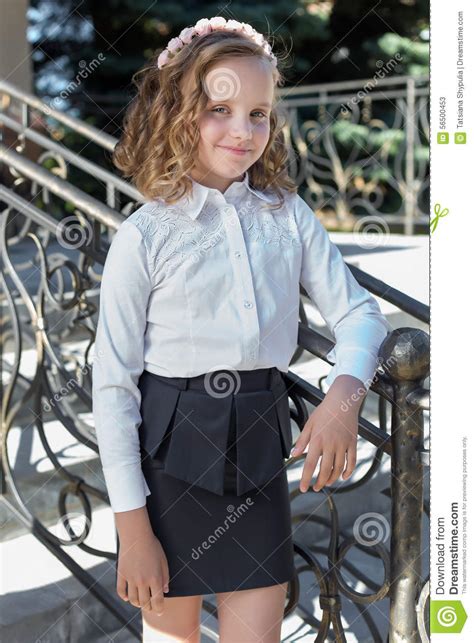 Beautiful Sweet Girl Schoolgirl In School Uniform Outside On A Sunny