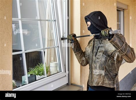 Burglar Trying To Break Into A House With A Crowbar Stock Photo Alamy