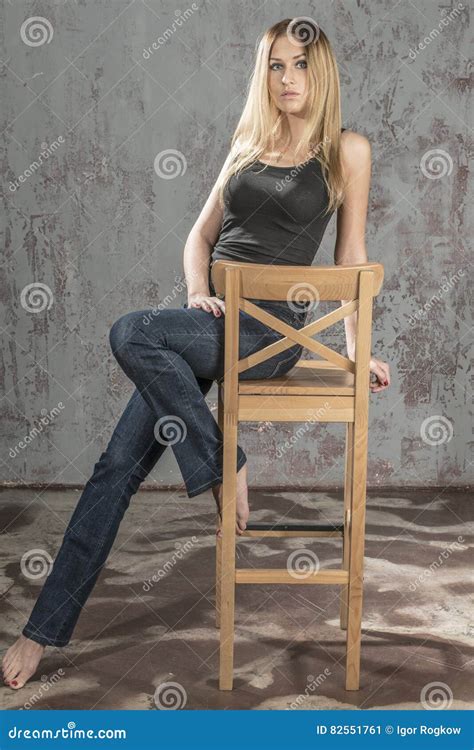 Young Slender Blonde Girl In Jeans And Shirt Posing Coquettishly Stock Image Image Of Cheerful