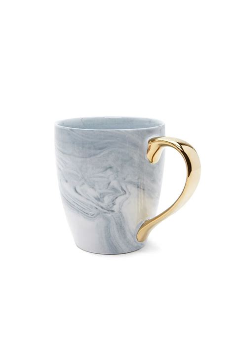 A Ceramic Mug Featuring A Marbled Design And A High Polish Handle