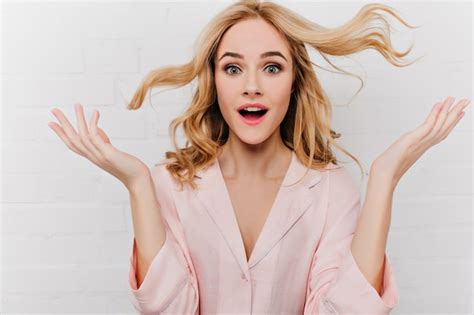 Free Photo Close Up Portrait Of Fair Haired Girl In Pink Attire Expressing Amazement On White