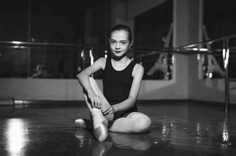 Premium Photo Portrait Of Pretty Little Ballerina Sitting On Floor And Tying Her Pointe In