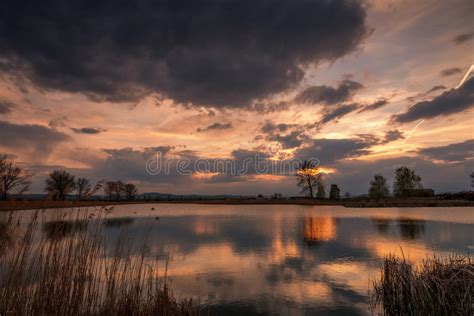 Sunset Over Calm Lake Sky Reflection In Water Stock Photo Image Of