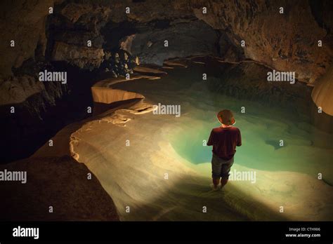 A Filipino Tour Guide Holds A Lantern Inside Sumaging Cave Or Big Cave