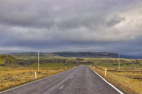 Photo Of Empty Road Under Cloudy Sky · Free Stock Photo