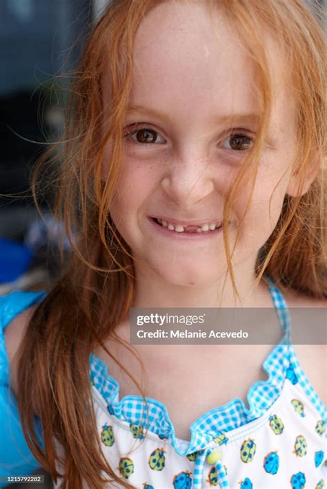 Young Red Headed Girl Close Up Looking Directly At The Camera Pigtails