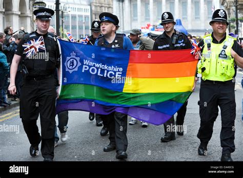 Warwickshire Police Officers With A Gay Rainbow Flag Marching To Celebrate Gay Rights In The
