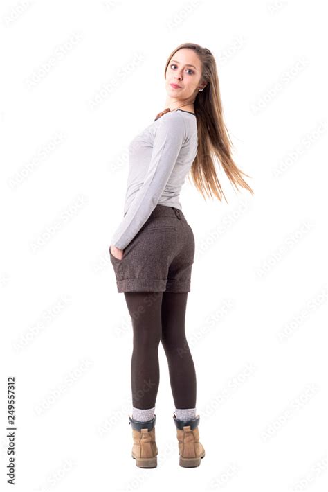 Rear View Of Charming Playful Cute Young Woman Turning At Camera