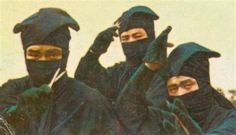 Three Men In Black Ninja Garb Are Posing For The Camera