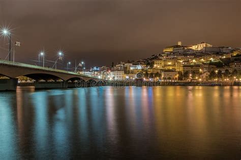 Bridge On The Sea In Coimbra With The Lights Reflecting On The Water