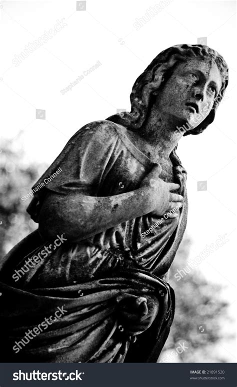 A Black And White Image Of An Angel Statue In Prayer Stock Photo