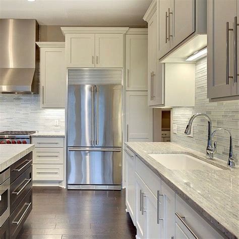 Ice white shaker cabinets can make any kitchen look larger and brighter. White Shaker cabinets with traditional crown molding | Our ...