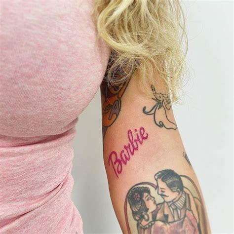Hand Poked Barbie Logo Tattoo On The Bicep
