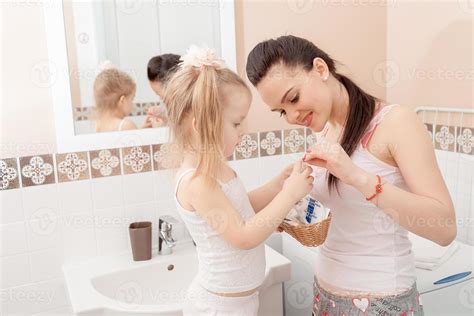 Mother And Daughter In Bathroom Stock Photo At Vecteezy