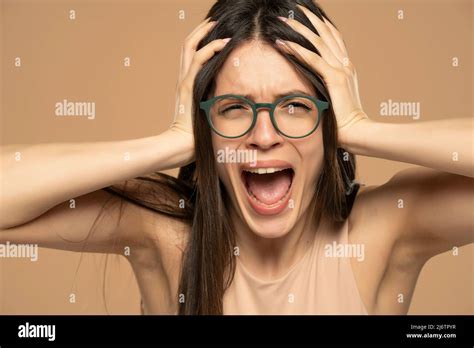 Closeup Portrait Stressed Frustrated Woman With Eyeglasses Screaming Isolated On Beige