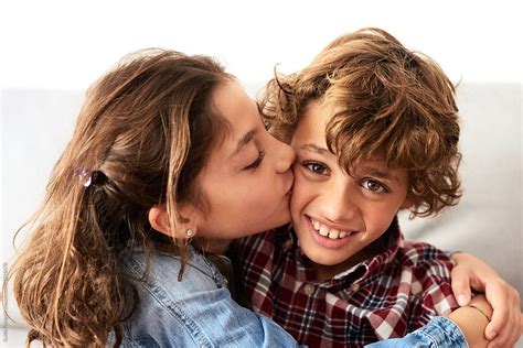 Sister Kissing Smiling Brother By Stocksy Contributor Guille
