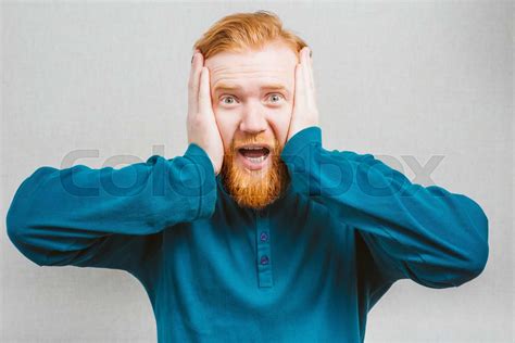 Furious Young Man Holding His Head In Hands Stock Image Colourbox
