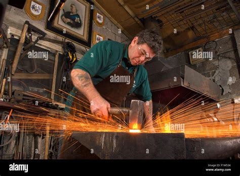 Blacksmith Simon Grant Jones Hammering Hot Metal With Sparks Flying In His Forge Where He Is A
