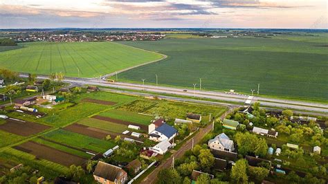Green Field And Village In Belarus Agriculture Prominent Photo