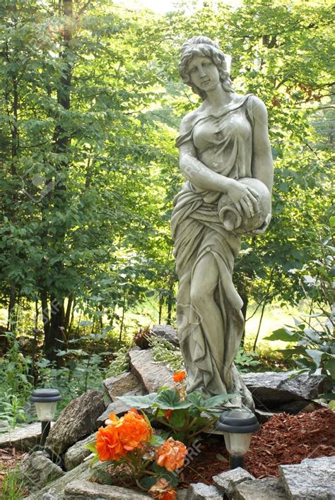 A Beautiful Garden Statue Of A Woman And A Vase Stock Photo Picture