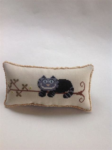 10.flip right side out and press. This is a hand stitched cross stitched pillow with a black ...