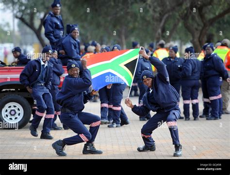 Police Officers Wave A South African Flag Following A Passing Out