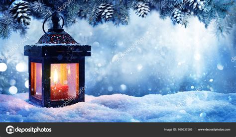 Christmas Lantern On Snow With Fir Branch In Evening Scene Stock Photo