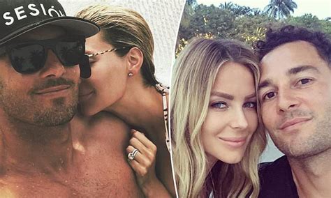 jennifer hawkins and husband jake wall look smitten as they cuddle up in a hammock at the beach