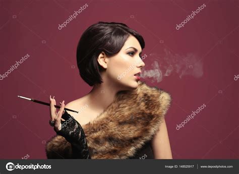 Woman Smoking With Cigarette Holder — Stock Photo © Belchonock 148525917