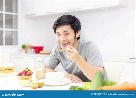 Attractive Handsome Man Eat Breakfast Or Cereal Fruits Milk On Stock