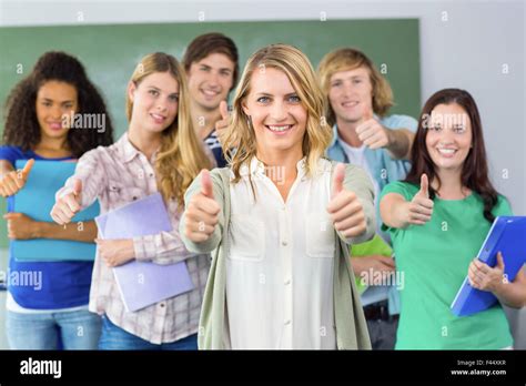 College Students Gesturing Thumbs Up Stock Photo Alamy