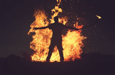 Person Standing In Front Of Fire During Night Time Photo Free Fire