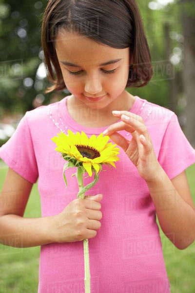 Portrait Of Girl Holding Flower Stock Photo Dissolve