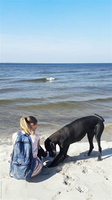 Back Girl On Beach With Dog By Stocksy Contributor Danil Nevsky