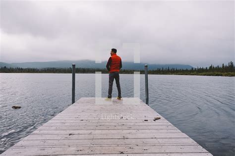 Man Standing On A Dock — Photo — Lightstock