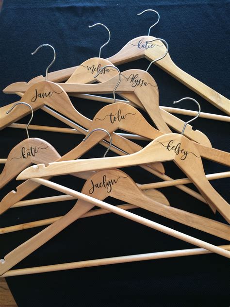 Custom painted hangers for weddings and bridesmaids gifts. DIY bridesmaids hangers with Silhouette machine for Katie's wedding #wedding #bridesmaids # ...