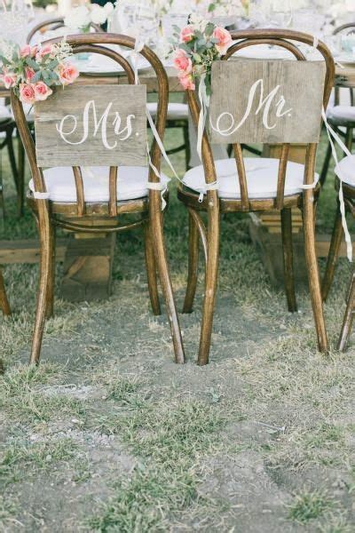 wedding chairs with mr and mrs signs on them