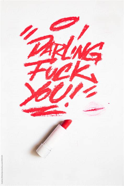 darling fuck you message written on white background with red lipstick by stocksy